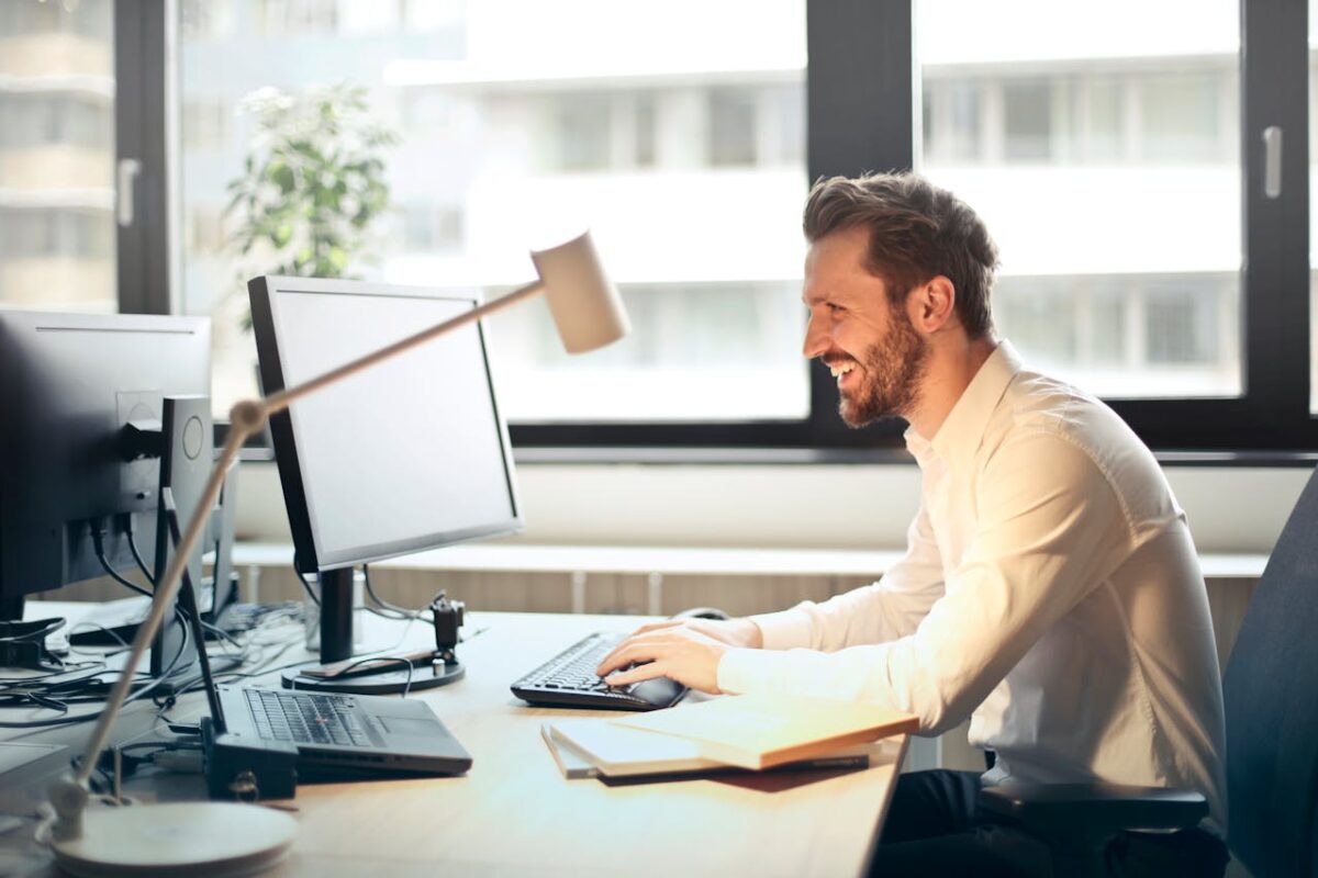 a guy at the computer working on the outbound lead generation.